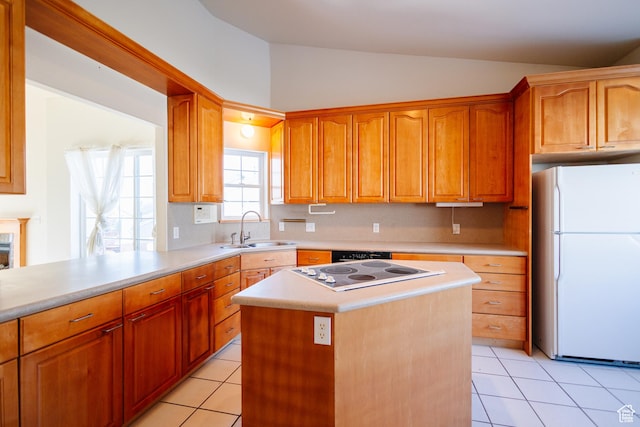 524 S Oak Ln W Unit 3, Tooele, UT 84074 - kitchen featuring a center island, light countertops, electric cooktop, freestanding refrigerator, and a sink