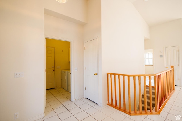 524 S Oak Ln W Unit 3, Tooele, UT 84074 - hall with light tile patterned floors, high vaulted ceiling, washing machine and dryer, and baseboards