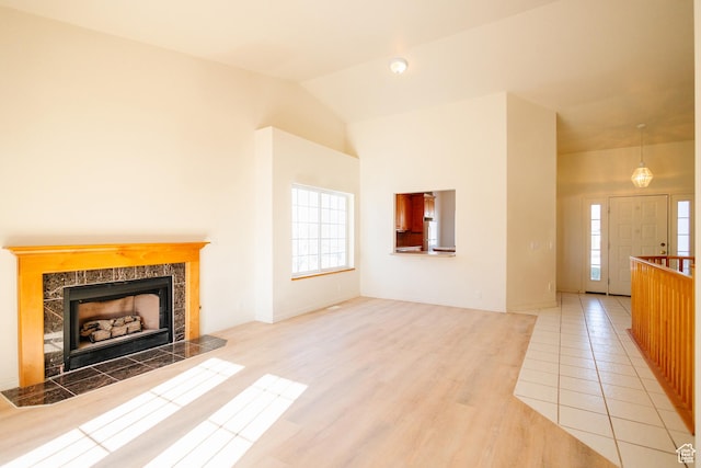 524 S Oak Ln W Unit 3, Tooele, UT 84074 - unfurnished living room with lofted ceiling, light wood-style flooring, and a fireplace