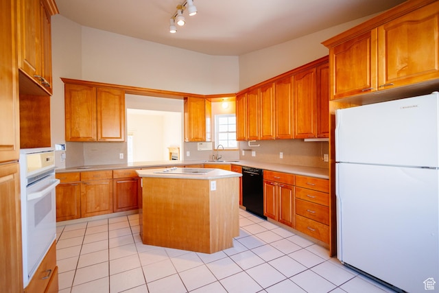 524 S Oak Ln W Unit 3, Tooele, UT 84074 - kitchen featuring brown cabinets, light countertops, a kitchen island, and black appliances