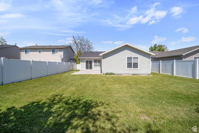 back of property with a lawn, a fenced backyard, and a patio