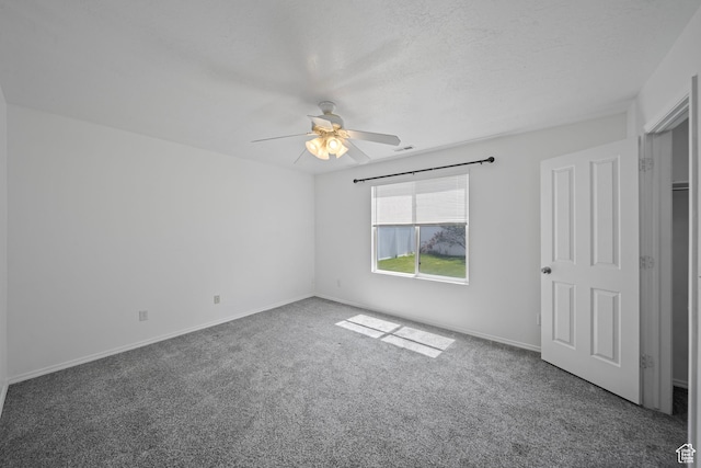 unfurnished bedroom with carpet floors, a ceiling fan, and baseboards