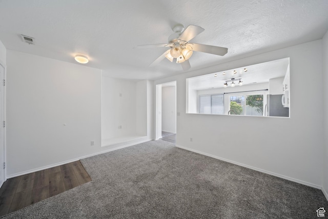 spare room featuring visible vents, carpet, baseboards, and ceiling fan