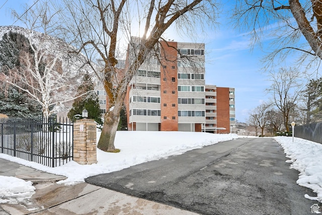snow covered property featuring fence