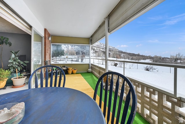 view of snow covered back of property