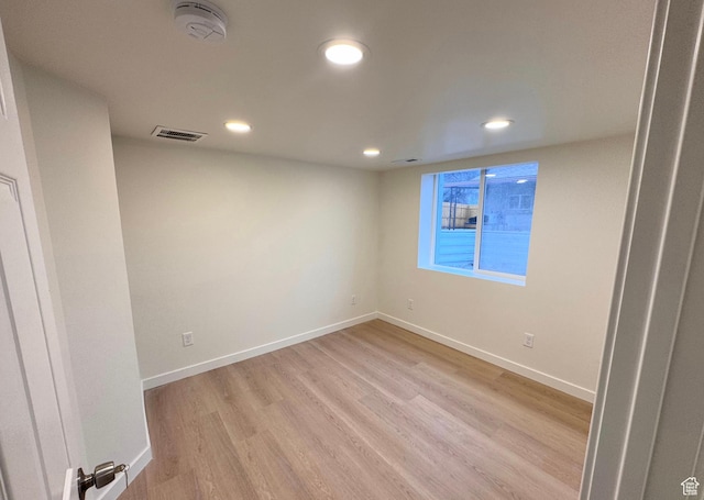 empty room with recessed lighting, baseboards, visible vents, and light wood finished floors