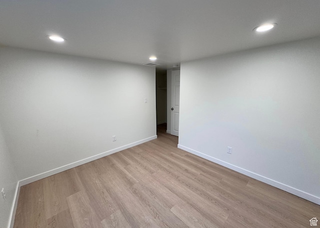 spare room with baseboards, recessed lighting, visible vents, and light wood-style floors