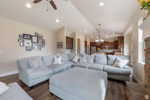 living room with lofted ceiling, baseboards, dark wood-type flooring, and recessed lighting