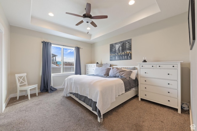 bedroom featuring carpet, recessed lighting, a raised ceiling, a ceiling fan, and baseboards