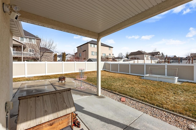 view of patio / terrace featuring an outdoor fire pit, a fenced backyard, and a residential view