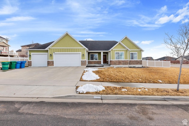 view of front of home featuring an attached garage, fence, board and batten siding, and concrete driveway