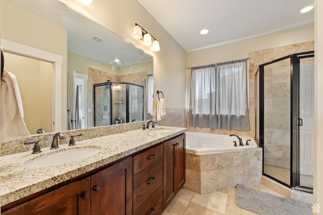 full bath with a stall shower, tile patterned flooring, visible vents, and a sink