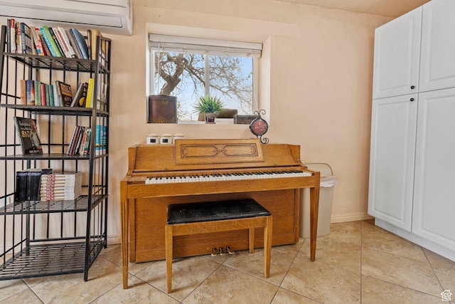 sitting room with light tile patterned floors and a wall mounted AC