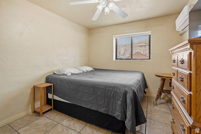 bedroom featuring light tile patterned floors, baseboards, and a ceiling fan