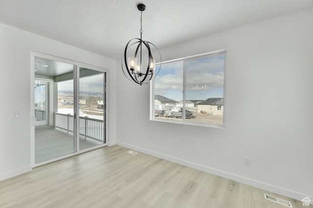 376 W Emma St Unit 623, Grantsville, UT 84029 - unfurnished dining area with a chandelier, light wood finished floors, and baseboards
