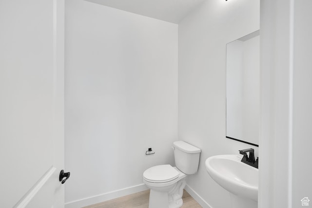 376 W Emma St Unit 623, Grantsville, UT 84029 - bathroom with a sink, wood finished floors, toilet, and baseboards