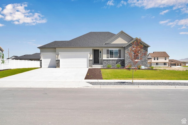 376 W Emma St Unit 623, Grantsville, UT 84029 - view of front of home featuring an attached garage, stone siding, concrete driveway, and stucco siding