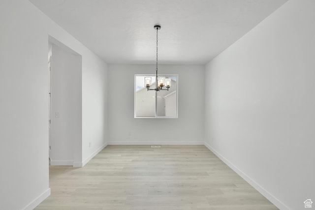 376 W Emma St Unit 623, Grantsville, UT 84029 - unfurnished room with a chandelier, light wood-type flooring, and baseboards