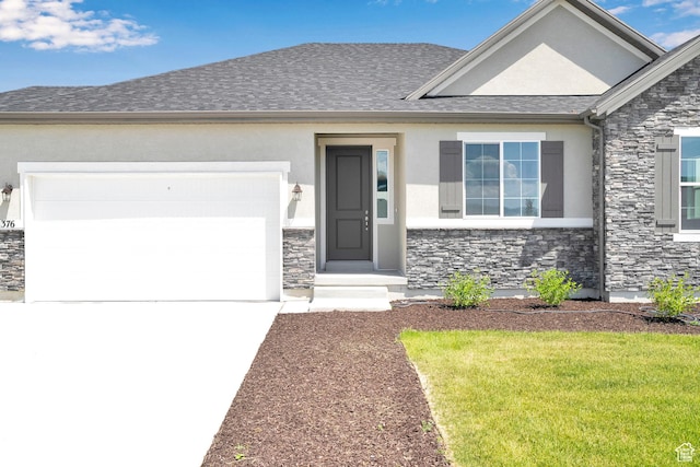 376 W Emma St Unit 623, Grantsville, UT 84029 - view of front of home with stone siding, driveway, stucco siding, a garage, and a front yard