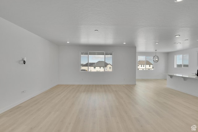 376 W Emma St Unit 623, Grantsville, UT 84029 - unfurnished living room with light wood-type flooring, recessed lighting, and baseboards