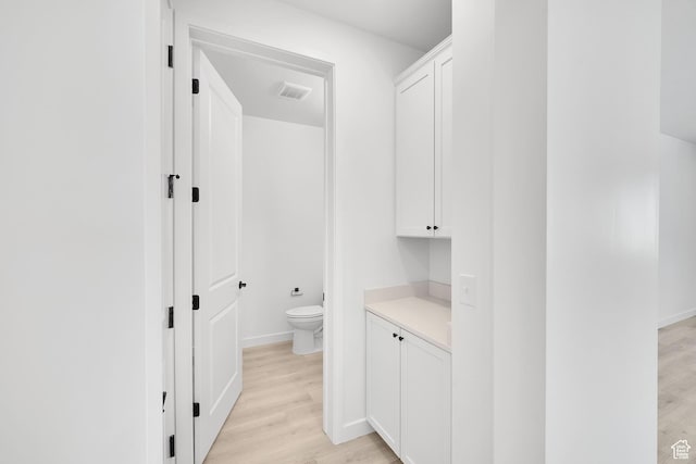 376 W Emma St Unit 623, Grantsville, UT 84029 - bathroom featuring wood finished floors, toilet, vanity, and baseboards