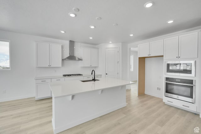 376 W Emma St Unit 623, Grantsville, UT 84029 - kitchen featuring wall chimney range hood, oven, a sink, built in microwave, and white cabinetry