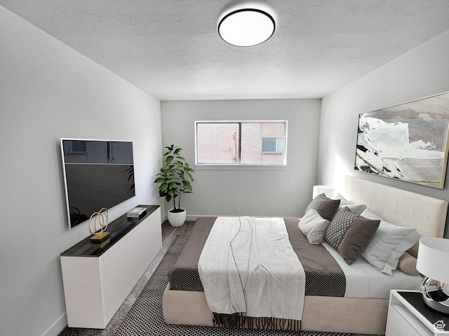 bedroom featuring carpet, a textured ceiling, and baseboards
