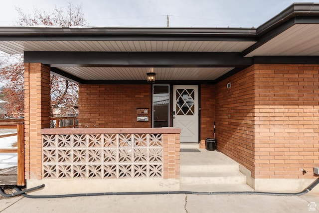 750 N 100 W, Logan, UT 84321 - doorway to property featuring brick siding and a porch