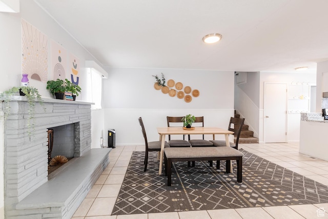 750 N 100 W, Logan, UT 84321 - dining room with light tile patterned floors, a fireplace with raised hearth, and stairs