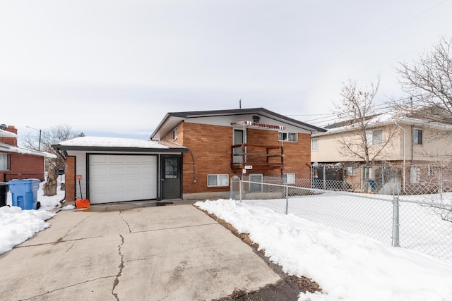 750 N 100 W, Logan, UT 84321 - view of front facade with an attached garage, brick siding, fence, and driveway