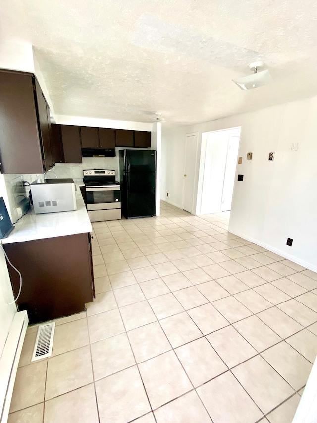 5444 W Bailiff Dr S, Kearns, UT 84118 - kitchen featuring light countertops, freestanding refrigerator, electric stove, visible vents, and white microwave