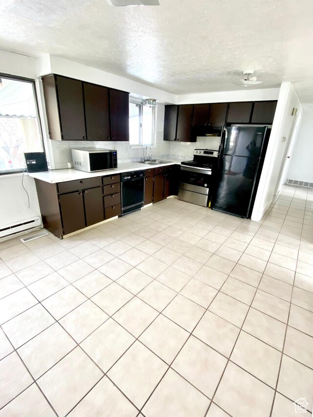 5444 W Bailiff Dr S, Kearns, UT 84118 - kitchen featuring light countertops, under cabinet range hood, a textured ceiling, a sink, and black appliances