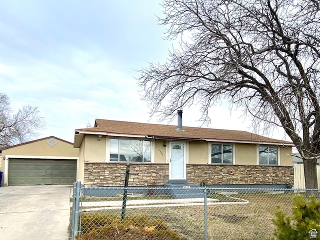 ranch-style home with stone siding, driveway, a garage, a fenced front yard, and stucco siding