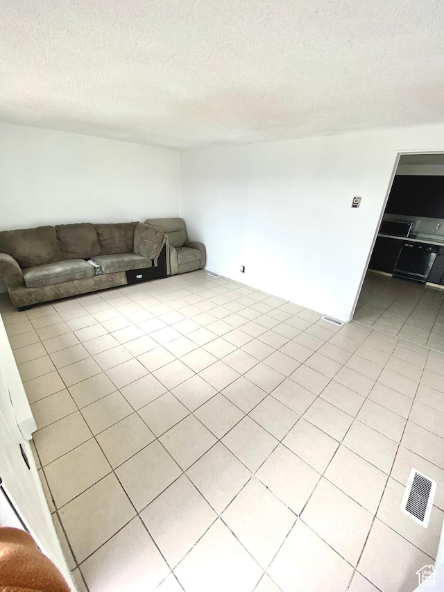 5444 W Bailiff Dr S, Kearns, UT 84118 - unfurnished living room with a textured ceiling, visible vents, and light tile patterned floors