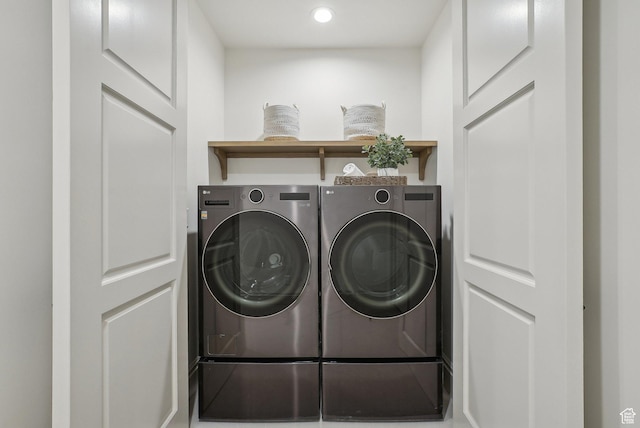 clothes washing area featuring laundry area and washing machine and clothes dryer