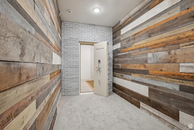 interior space with wooden walls and light colored carpet
