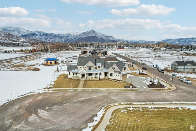 snowy aerial view featuring a mountain view