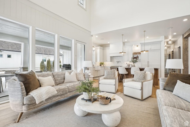 living area with a high ceiling and recessed lighting