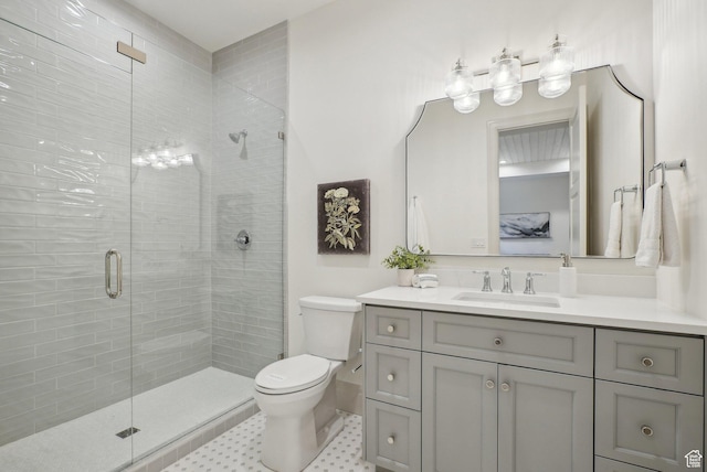 full bath featuring toilet, a stall shower, and vanity