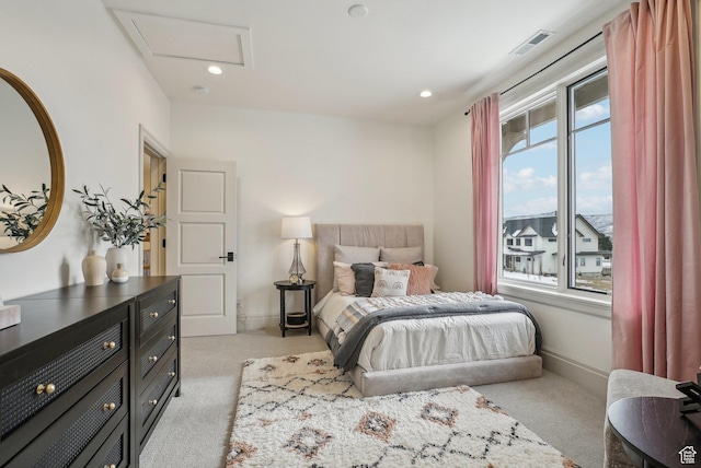 bedroom featuring recessed lighting, light colored carpet, visible vents, and attic access