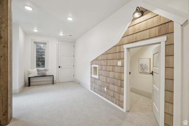 hall with recessed lighting, light carpet, and baseboards