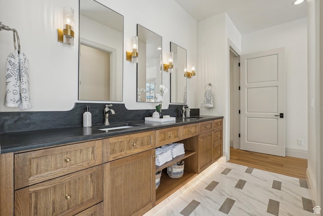 full bath with double vanity and a sink