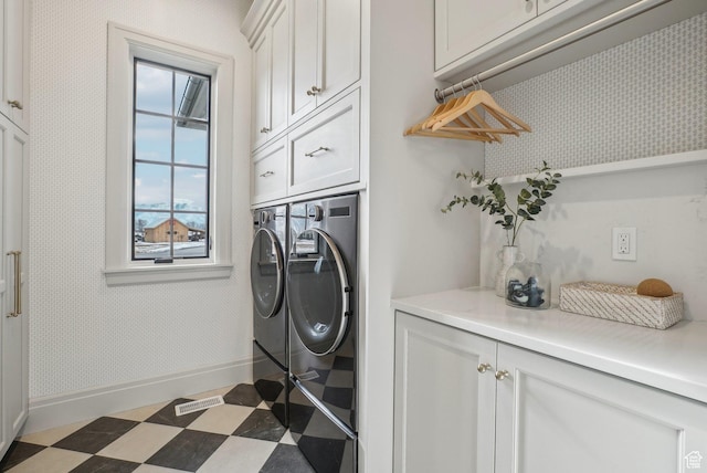 laundry area featuring cabinet space, baseboards, visible vents, dark floors, and separate washer and dryer
