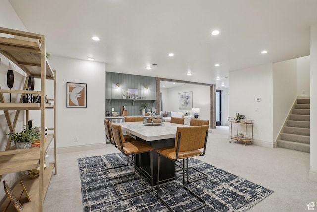carpeted dining area with recessed lighting, stairway, and baseboards