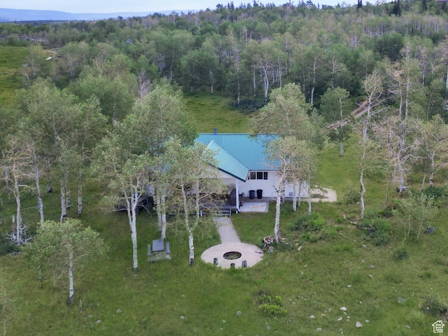 birds eye view of property with a view of trees