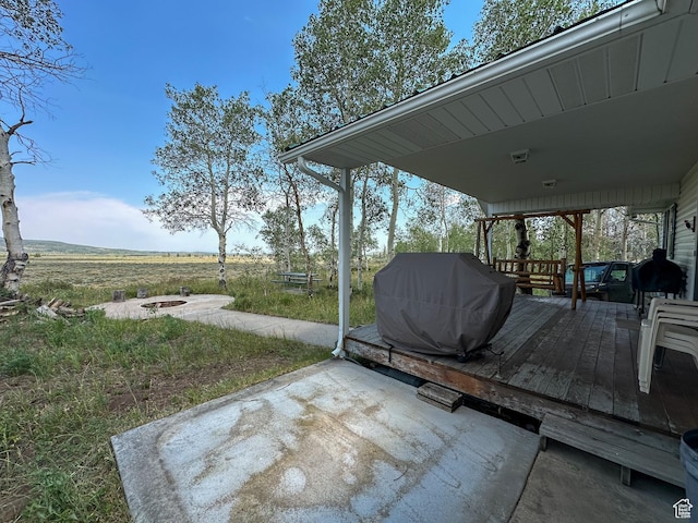 view of patio featuring a grill and a fire pit