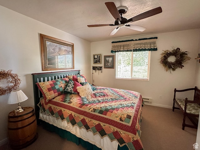 bedroom featuring ceiling fan, a baseboard radiator, carpet flooring, and baseboards
