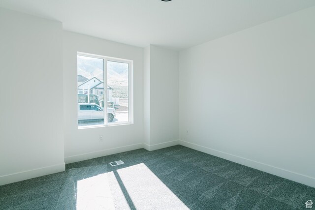 4111 N Ophir Dr, Eagle Mountain, UT 84005 - unfurnished room with dark colored carpet and baseboards