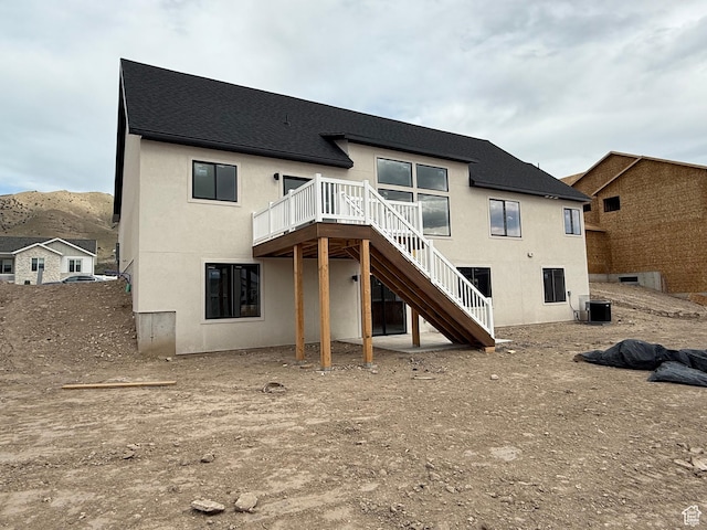 4111 N Ophir Dr, Eagle Mountain, UT 84005 - back of property with stairs, a wooden deck, stucco siding, a shingled roof, and central AC unit
