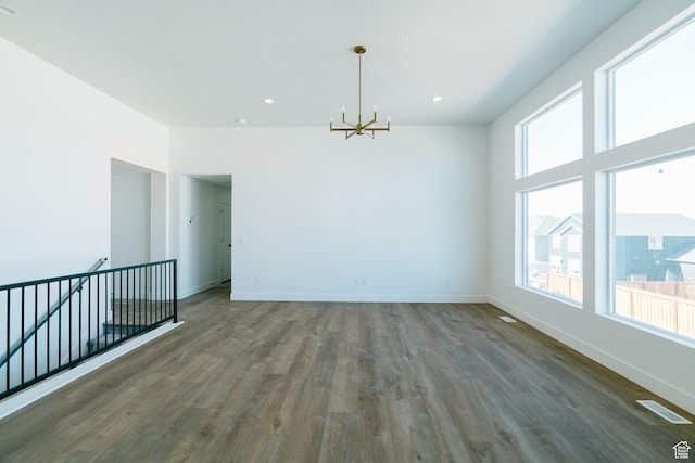 4111 N Ophir Dr, Eagle Mountain, UT 84005 - unfurnished room featuring a chandelier, wood finished floors, baseboards, and recessed lighting